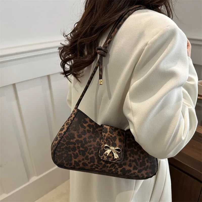 Casual women's PU handbag with sandwich pocket organisation in black colour showing 27 cm width