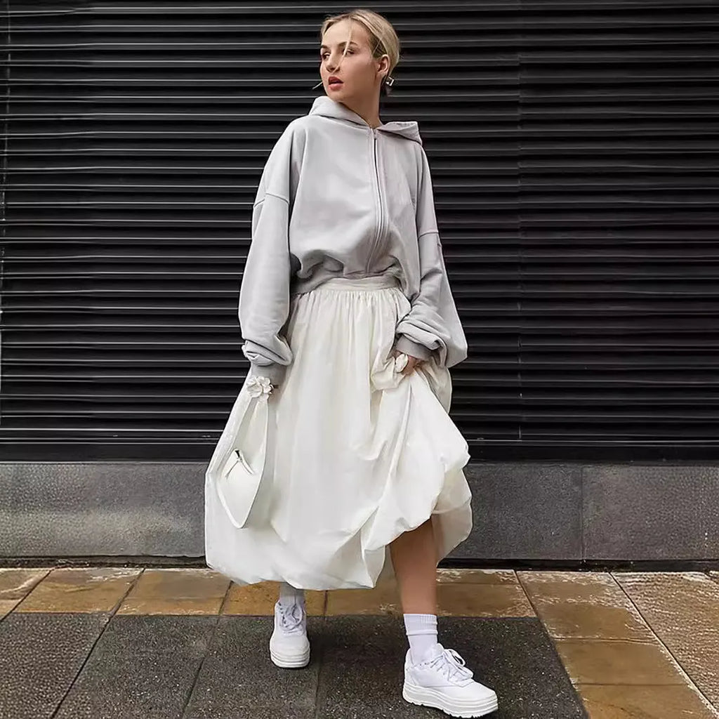Women's solid colour cotton long skirt on a hanger, available in black or white.