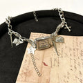 Dark multi-layer cross necklace with twin clavicle chains on model