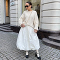 Women's solid colour cotton long skirt on a hanger, available in black or white.