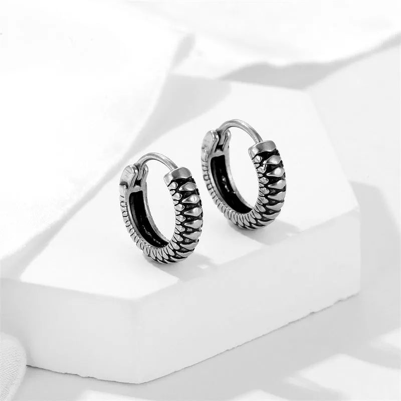 Silver geometric earrings with a retro twist striped pattern, made from titanium steel.