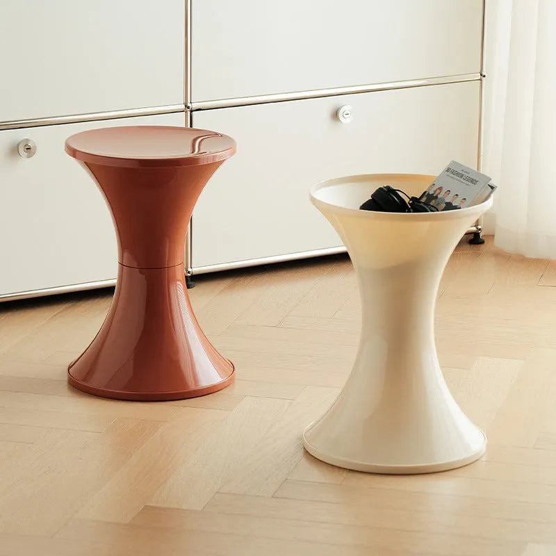 A plastic hourglass-shaped shoe changing stool in a choice of colours.