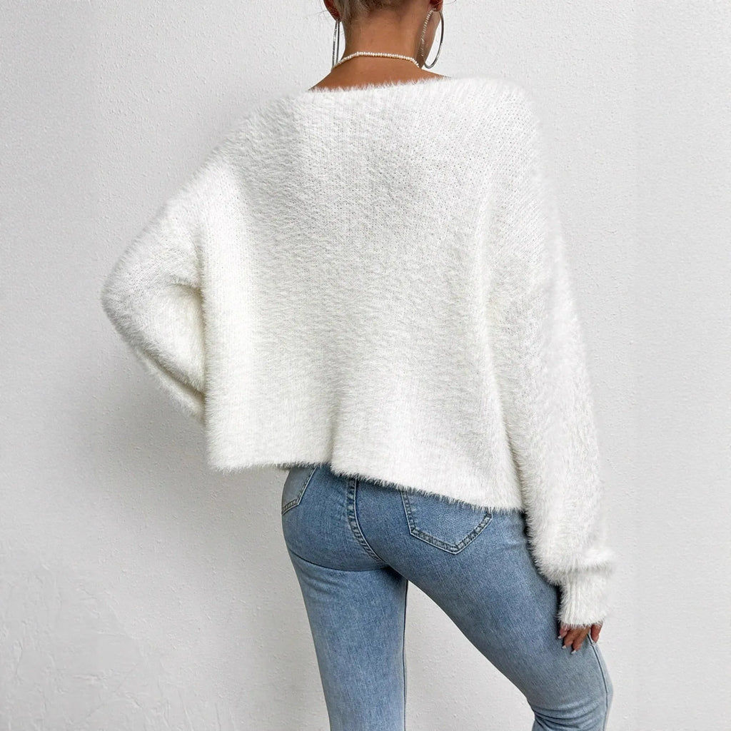 White women's V-neck cardigan sweater made from polyester knit fabric