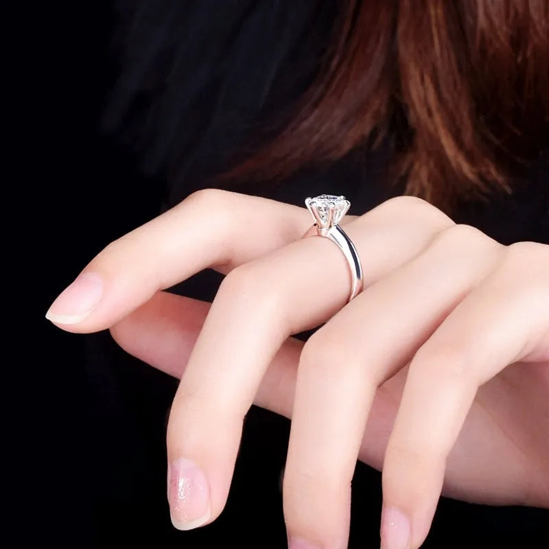 White gold plated zircon ring with six-claw setting and geometric shape on finger