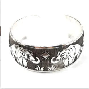 Ethnic carved open Miao silver bracelet showing turtle and elephant motifs