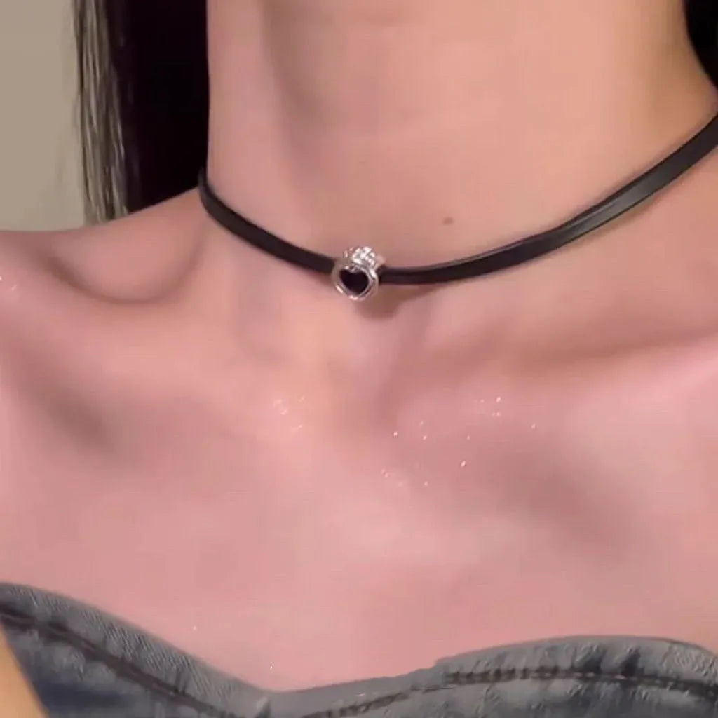 Women's creative necklace set showing a double-layer leather heart necklace and a single crystal heart pendant on a metal chain.