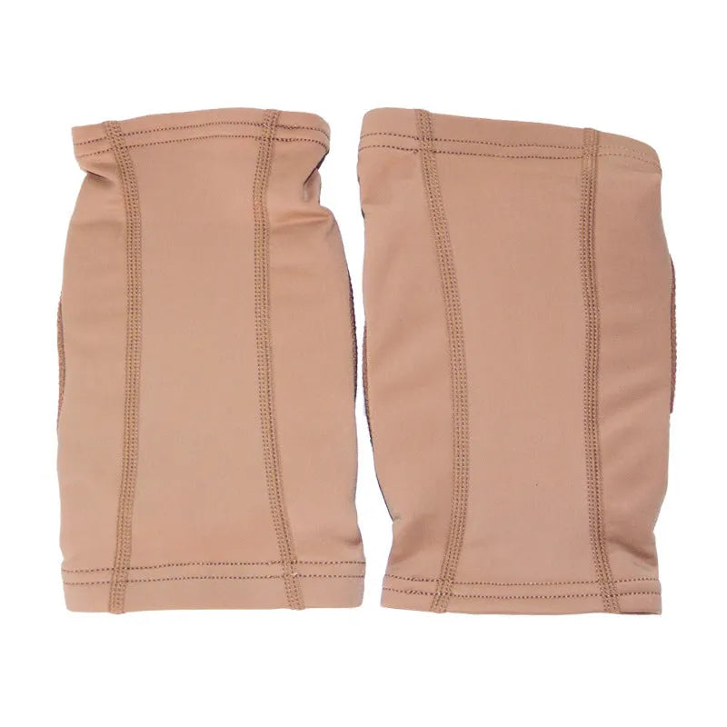 A pair of skin-colour ballet dance knee pads with elastic straps, shown laid flat.