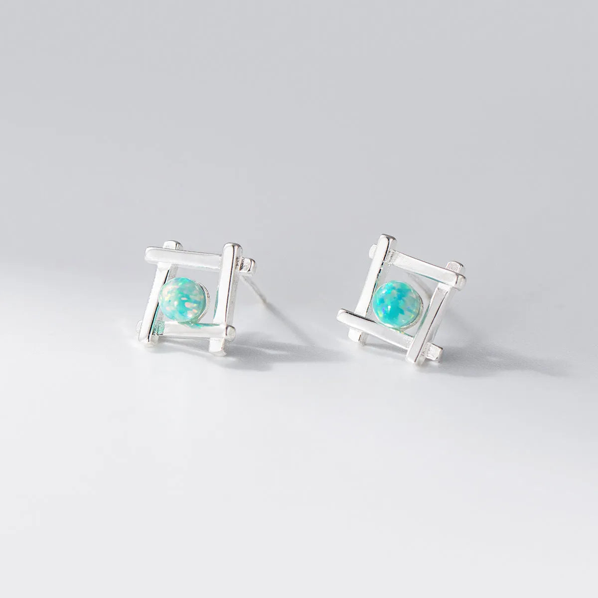 Geometric cross quadrangle stud earrings in 925 silver with silver or gold finish options