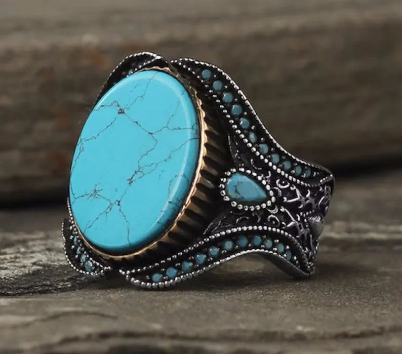 Men's round turquoise ring in antique silver alloy showing simple design and stone setting