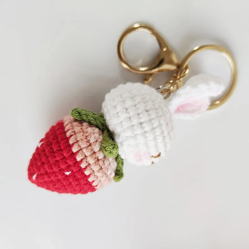 Hand-woven white wire pendant with rabbit strawberry cartoon design and key attachment