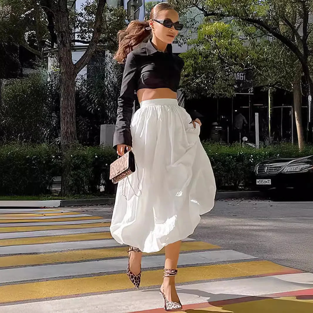 Women's solid colour cotton long skirt on a hanger, available in black or white.