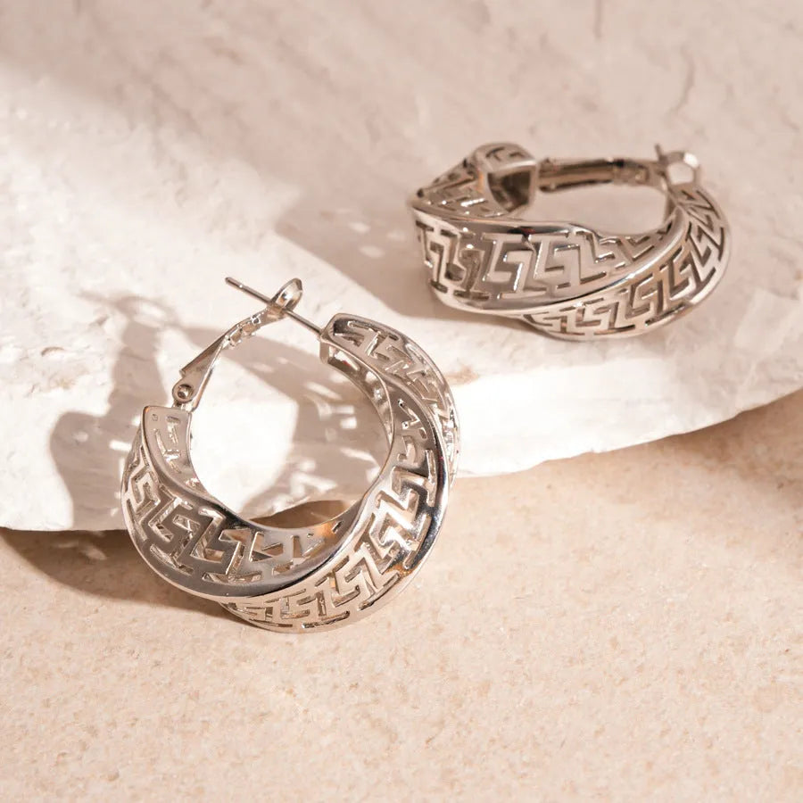Women's geometric hollow stud earrings with twisted round design in gold or silver finish