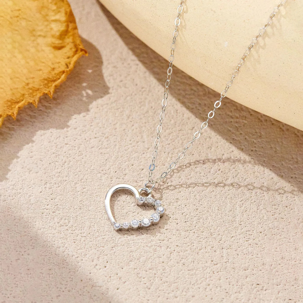 S925 sterling silver hollow heart pendant necklace on a regular chain, shown in gold and platinum colour options.