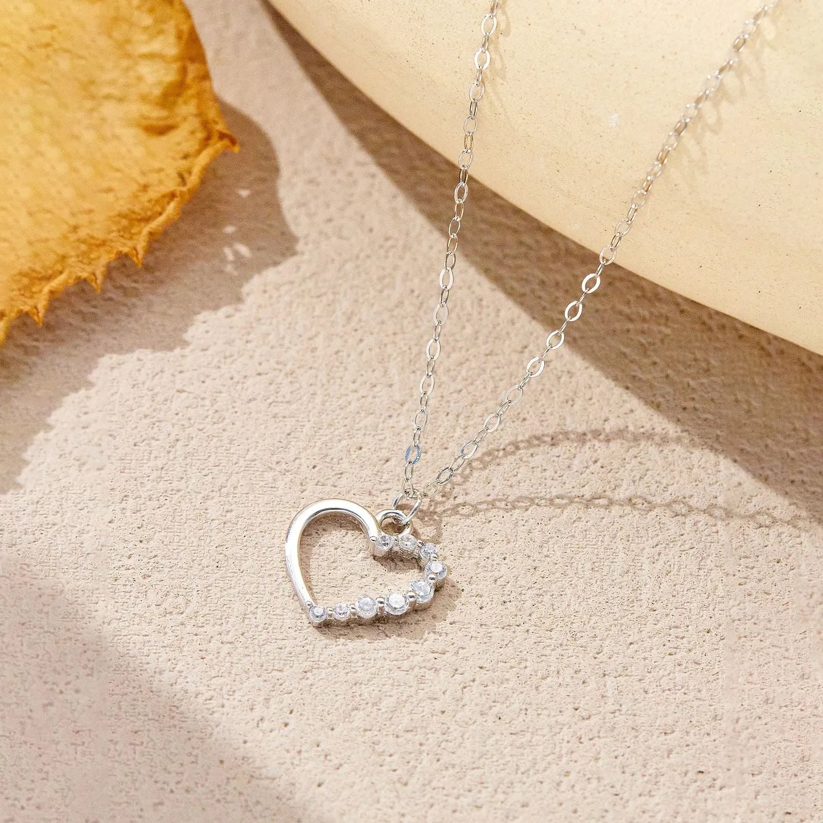 S925 sterling silver hollow heart pendant necklace on a regular chain, shown in gold and platinum colour options.