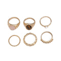 Six light gold geometric alloy rings with irregular shapes and electroplated finish arranged as a complete set