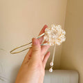 Close-up of a retro-style U-shaped alloy hair clip with a purple peony flower and tassel decoration.