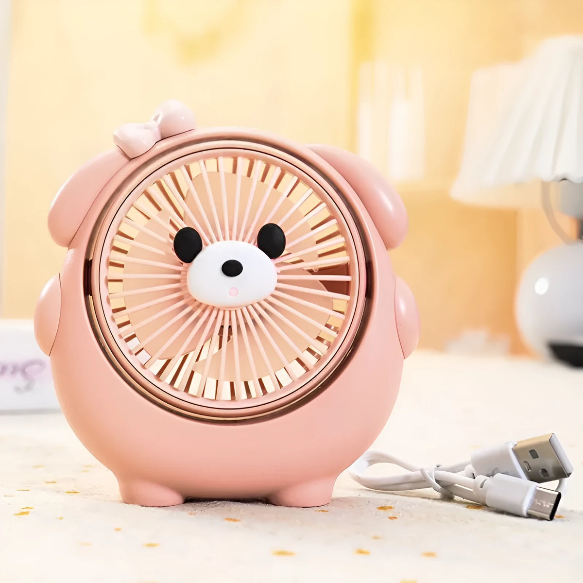 Cute dog shaped USB powered desk fan with three speed settings on a wooden table.