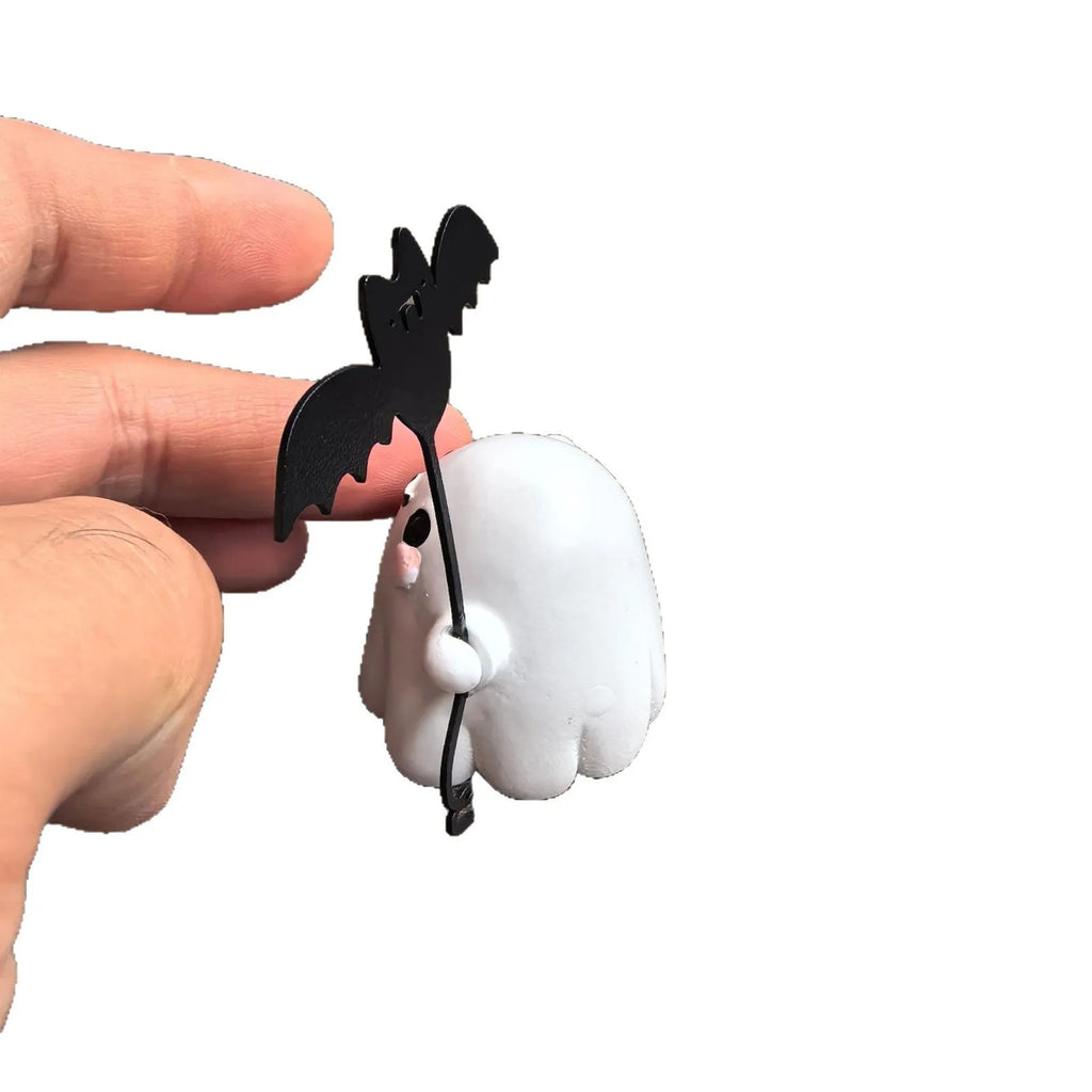 Small resin statue of a ghost dog with a bat, a miniature Halloween ornament.