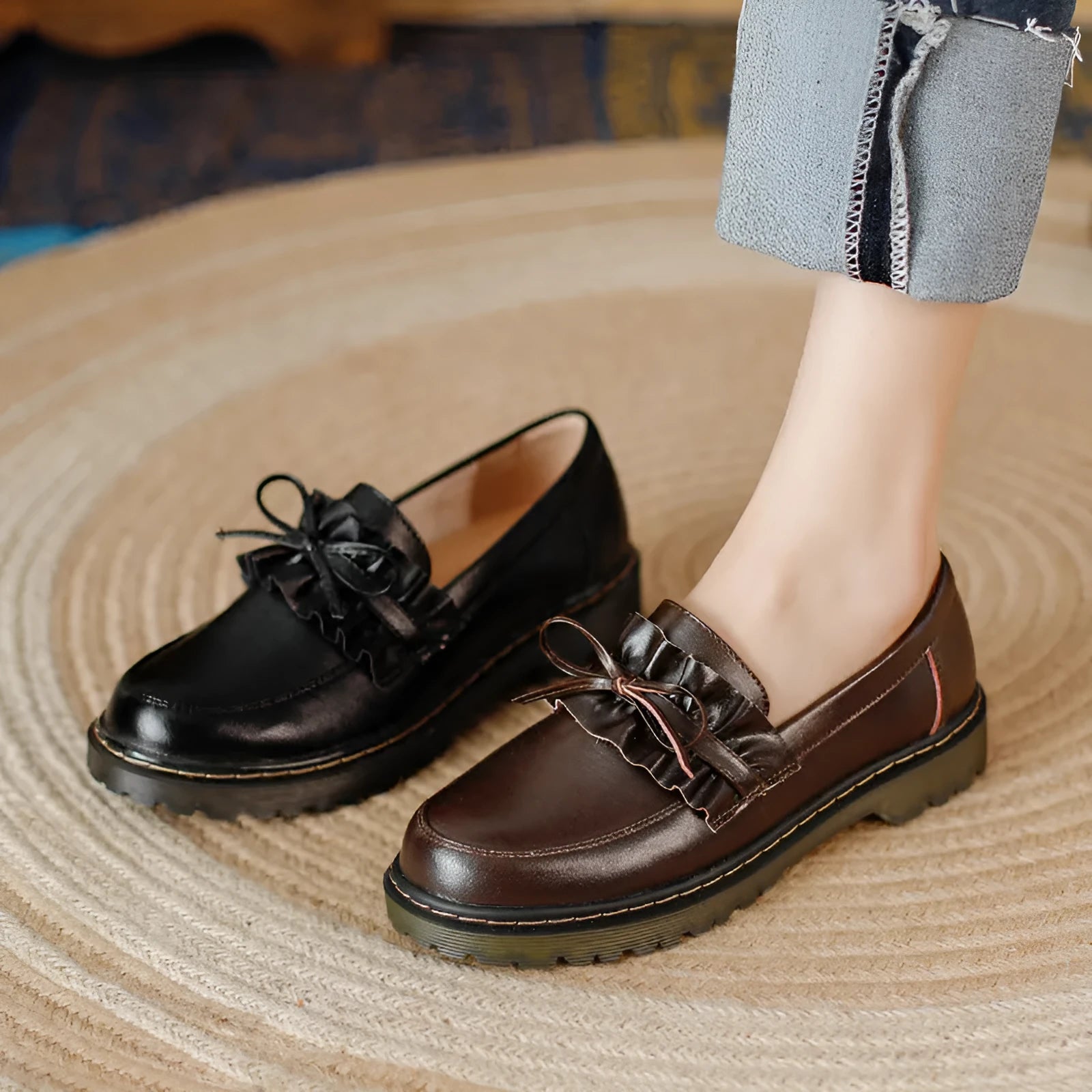Black and brown women's round toe leather boots with chunky flat heels on display