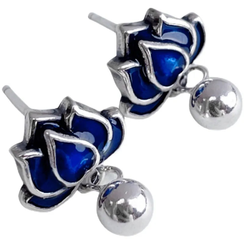 Blue Lotus earrings with a flower stud and dangling seedpod tassel in silver-tone alloy.