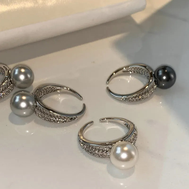 Women's adjustable open ring with geometric design and black pearl finish on copper.