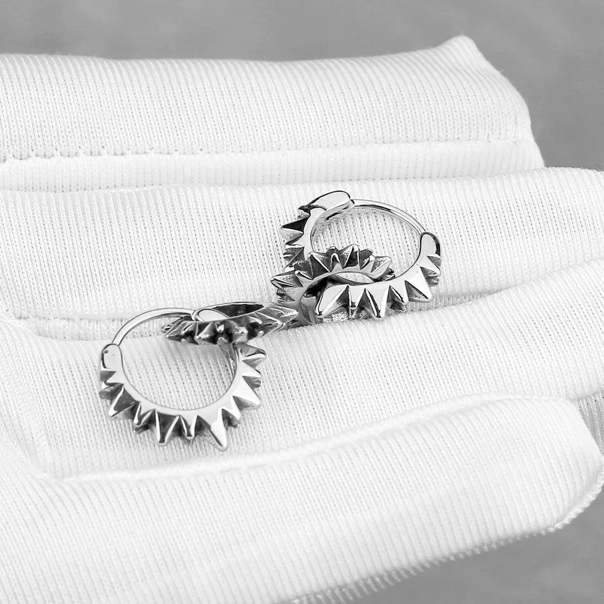Polished stainless steel round hoop earrings in a steel colour with a simple retro design.