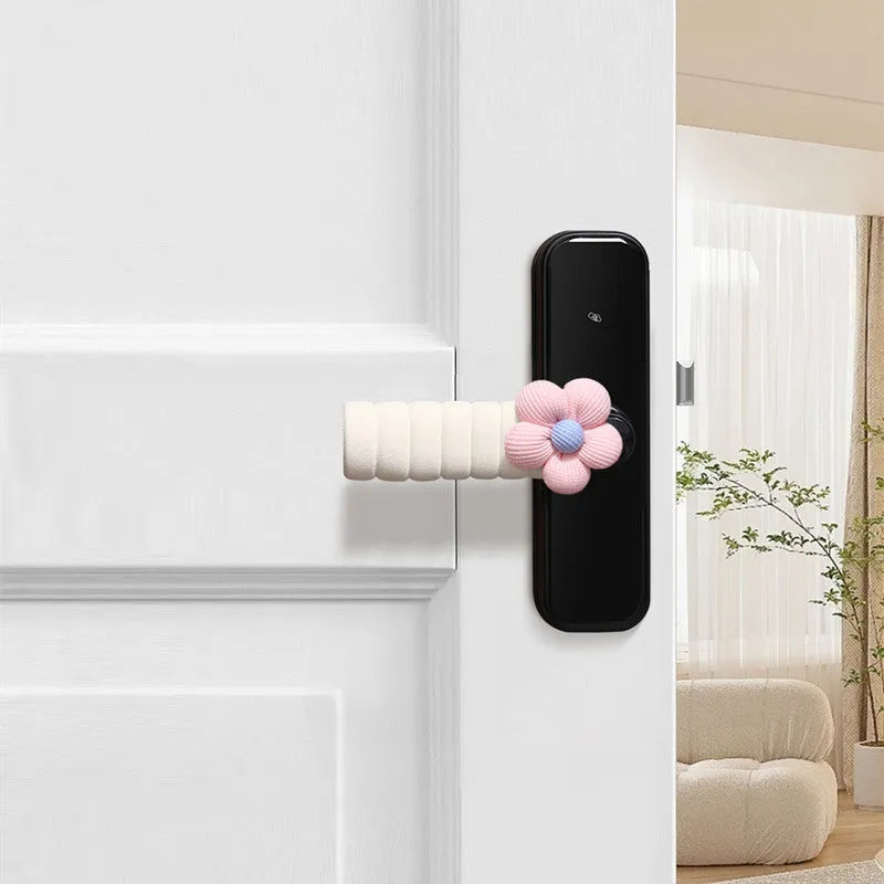 Flower pattern soft PEVA door handle protective cover on a round door knob.