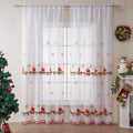 Pair of red and white Christmas curtains with embroidered snowflake design, showing light filtering through.