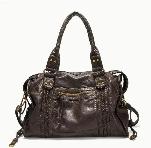 Women's brown soft PU French retro motorcycle shoulder messenger bag with woven design on a table.