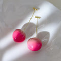 Acrylic peach fruit earrings in small and large size variations with copper findings