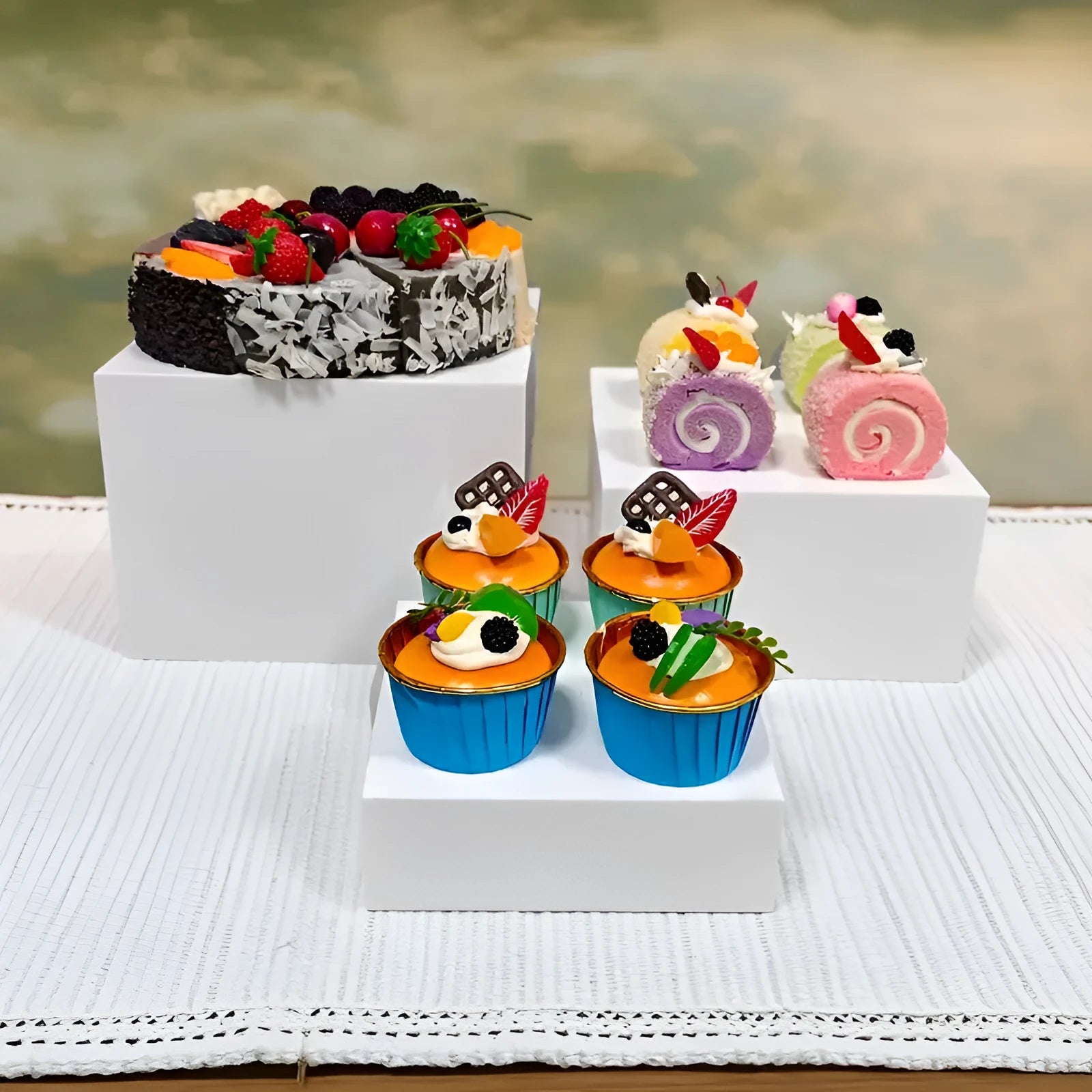 White plastic cube dessert display stand with six modular stacking components for cake presentation