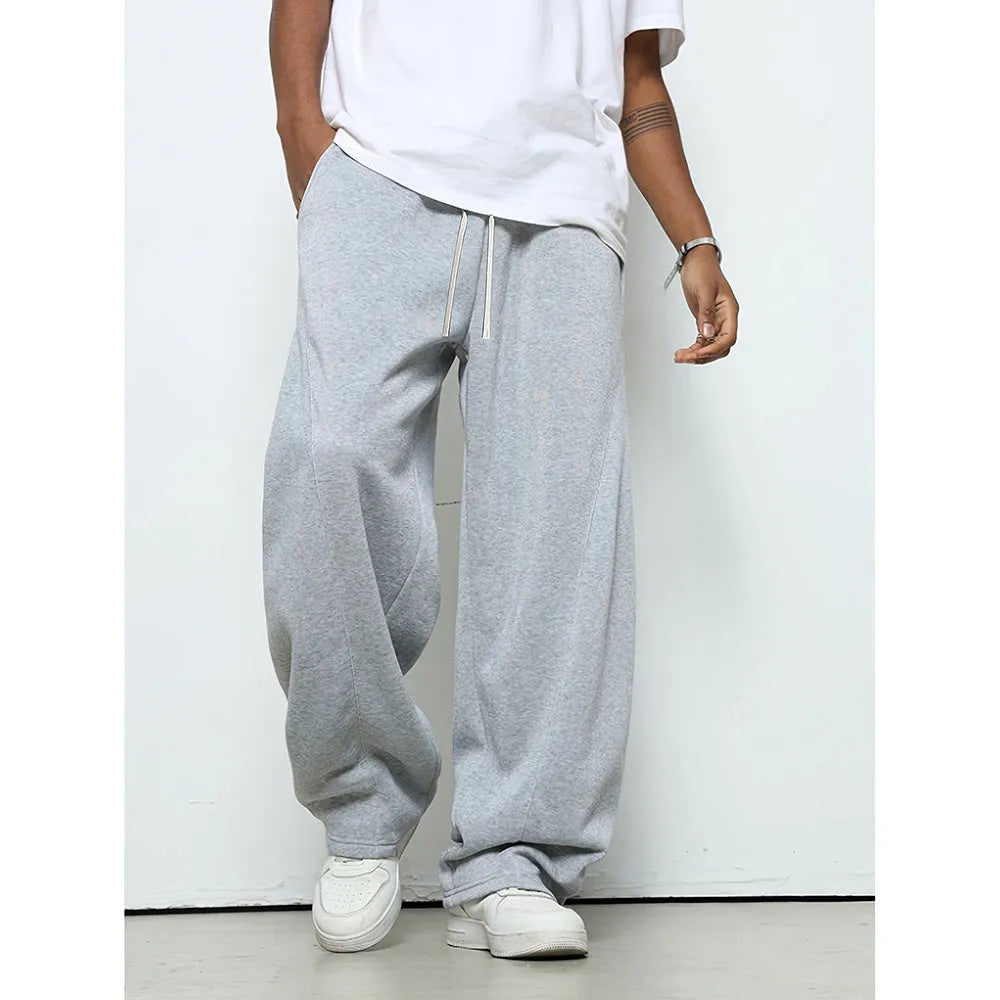 Men's straight-leg casual trousers in black with a drawstring waist, shown flat.