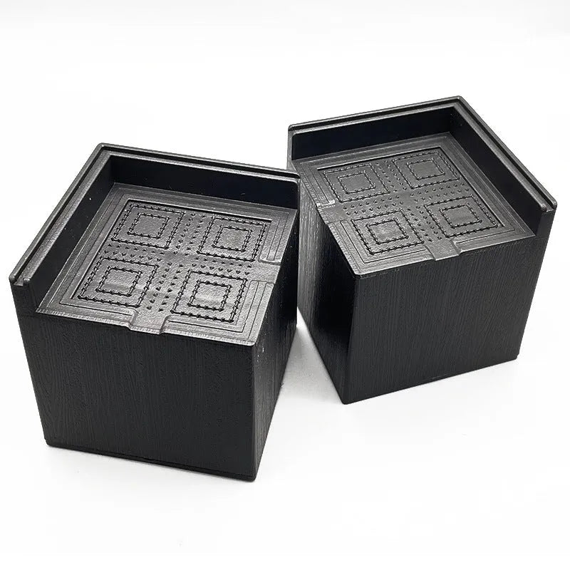 Black plastic bed foot mat set for furniture height increase in four piece pack