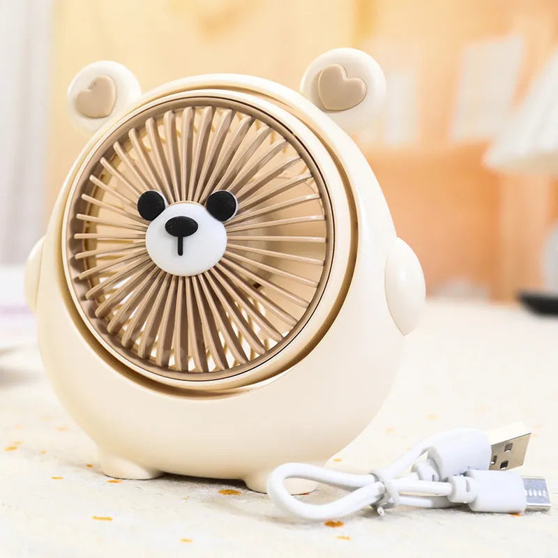 Cute dog shaped USB powered desk fan with three speed settings on a wooden table.