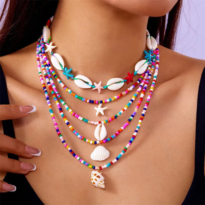 Five-piece women's necklace set with shell beads and adjustable chains in blue and coloured variations
