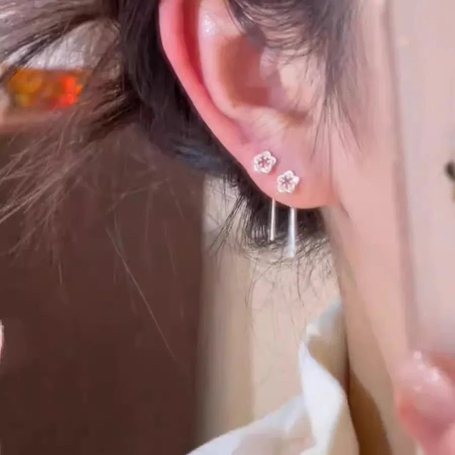 Silver colour hollow flower stud earrings with petal design on alloy posts