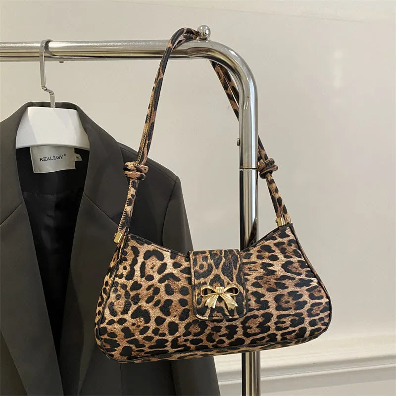 Casual women's PU handbag with sandwich pocket organisation in black colour showing 27 cm width