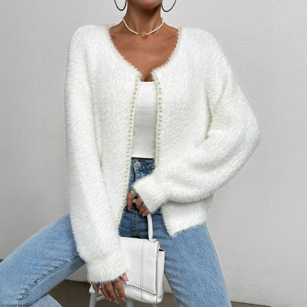 White women's V-neck cardigan sweater made from polyester knit fabric