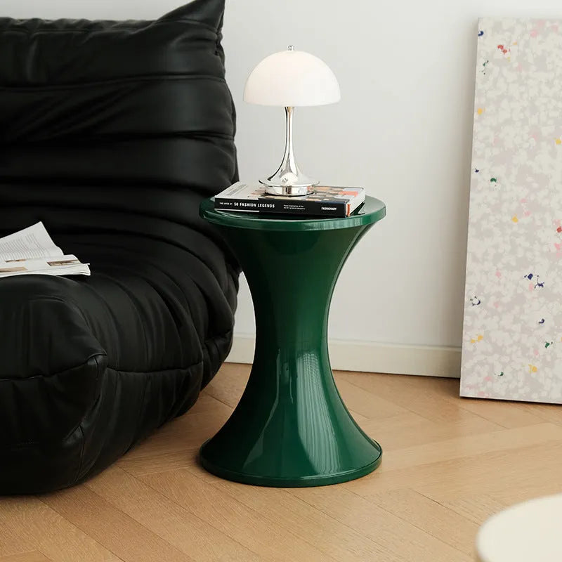 A plastic hourglass-shaped shoe changing stool in a choice of colours.