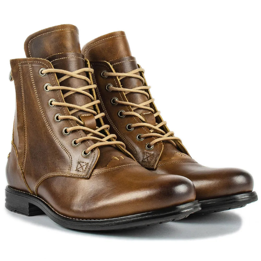 Black and brown two-tone leather ankle boots with side zipper and low heel.