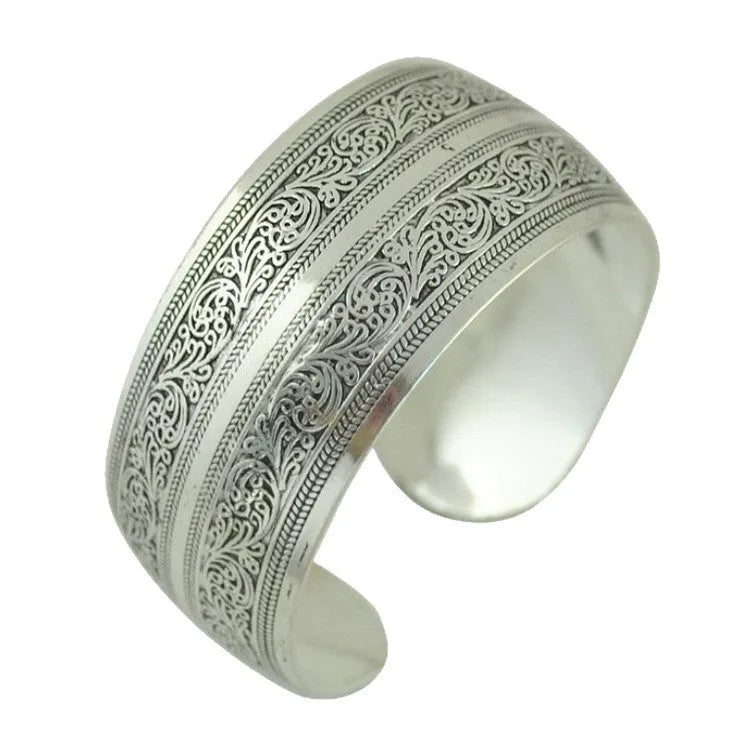 Ethnic carved open Miao silver bracelet showing turtle and elephant motifs