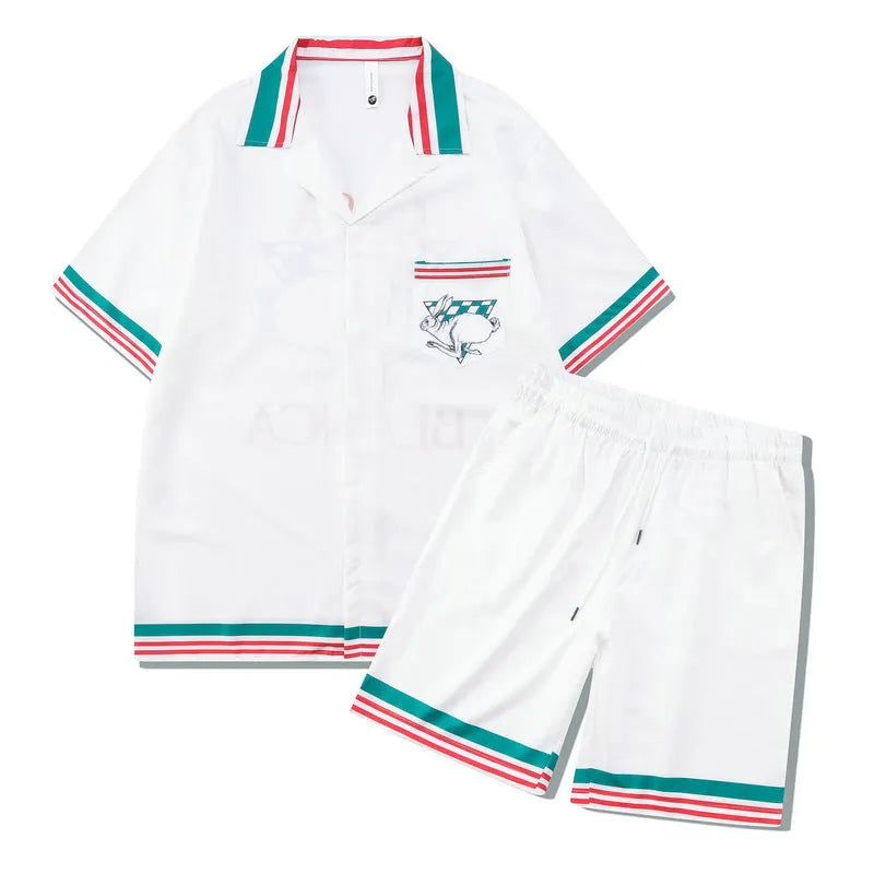Men's and women's plaid print beach shirt and trouser casual outfit set on a hanger.