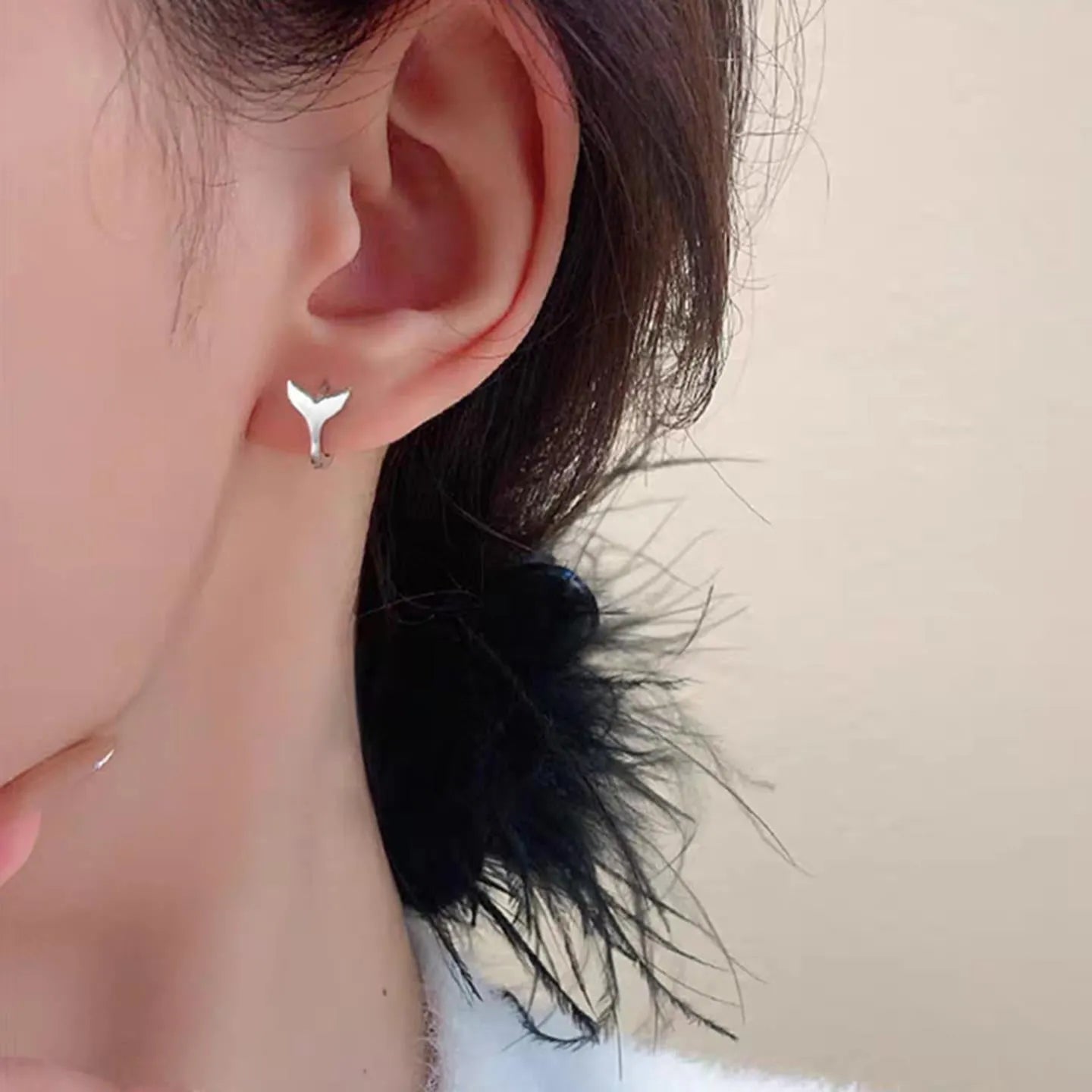 Women's copper fishtail design earrings in white gold or yellow gold colour.