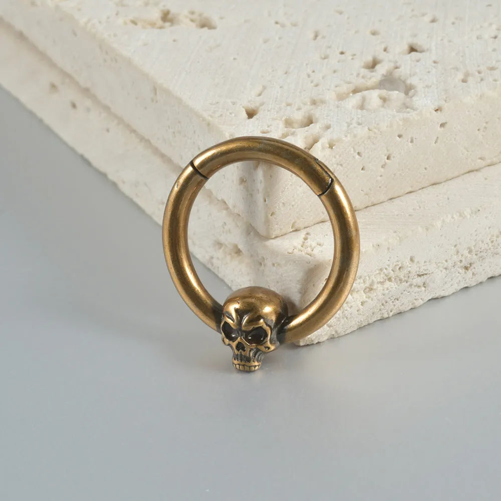 Copper ghost head earrings in antique gold or silver finish, single or triple design.