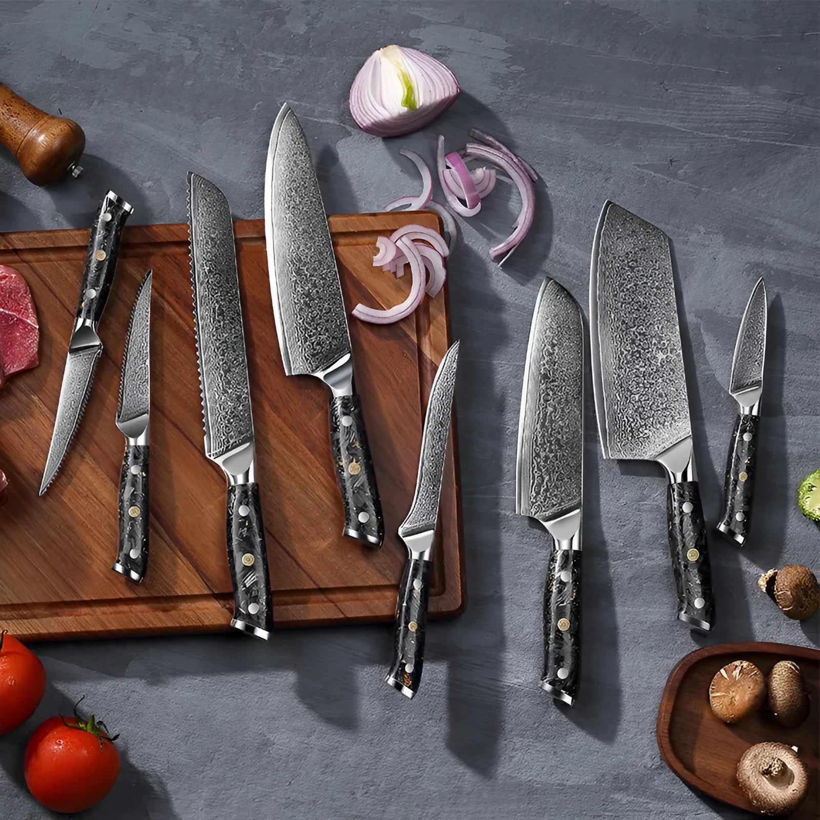 Damascus steel kitchen knife set showing eight different blade sizes with fishbone pattern detailing