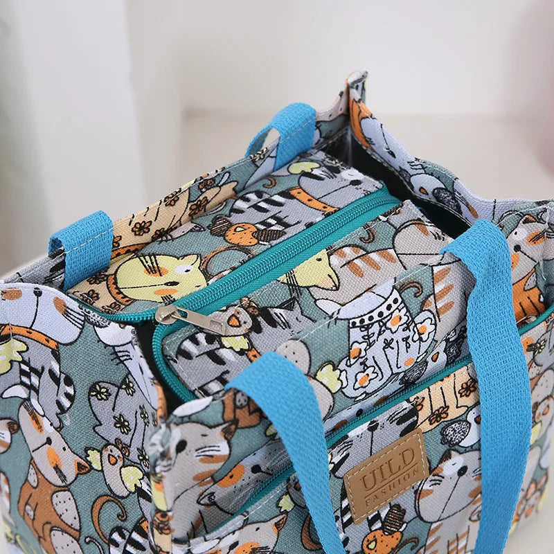 Women's portable square canvas bag with aluminium handle in a choice of printed designs including flowers and cats.