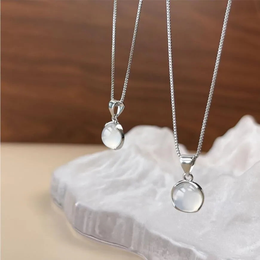 Women's oval artificial crystal pendant necklace with eight-point star design on an adjustable box chain.
