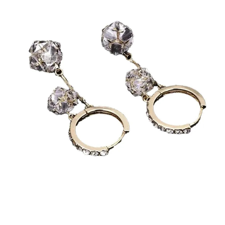 Women's silver-toned drop earrings with a double pendant and rhinestone ball tassel on an ear clip.