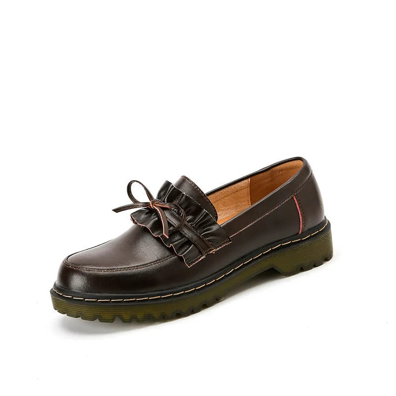 Black and brown women's round toe leather boots with chunky flat heels on display