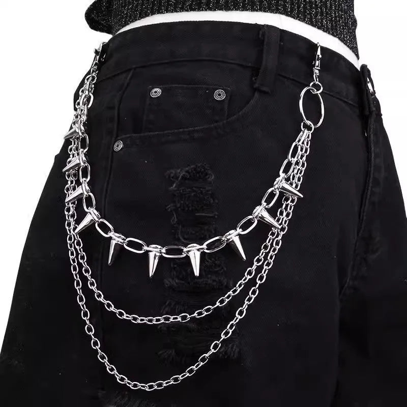 Silver punk pants chain with double layers, zipper detail, and rivet accents against dark background